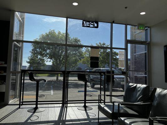 View looking outside. High top tables and chairs for the on the go business folks/students to continue working.