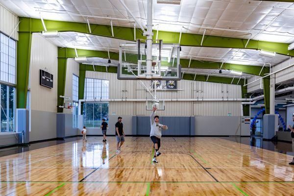 Multi-sport gymnasium featuring drop-in pickleball, volleyball, and basketball