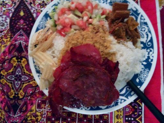 Made this at home. Spiced, cured, beef slices, lentil soup over white rice, pickled mangoes, fresh salad, some chips. Great selection