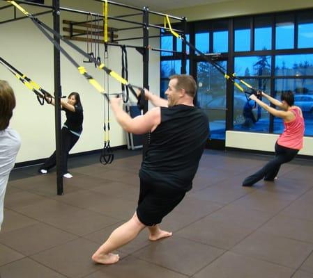 Jennifer leading a final stretch on the TRX.