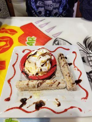 We ordered the Churro dessert and we started to eat so here is a picture with two Chrrros left with ice cream. SOOO DELICIOUS!