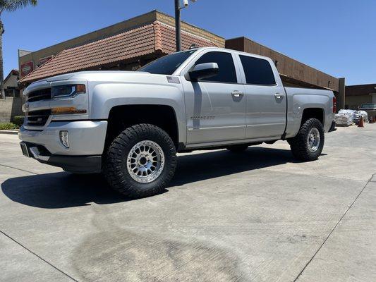 Chevy Silverado 1500 with Bilstein 5100 adjustable struts set at a leveling height with 17 inch Tremor wheels and 33 inch Nitto tires