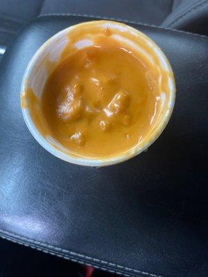 Spoiled clumpy disgusting cheese sauce.