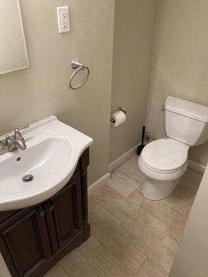 Bathroom tile, drywall, and toilet installation work.