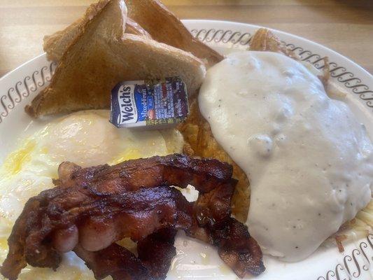 Two eggs over easy, toast, bacon, hash browns with sausage gravy