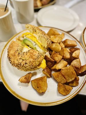 Egg, avocado, & cheese on a bagel and home fries