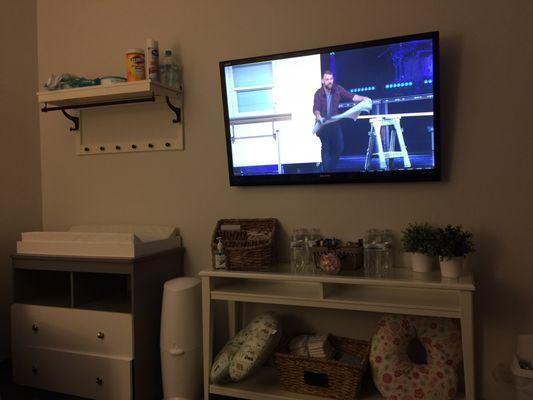 Mom and baby room with all the essentials and a tv to watch the service.