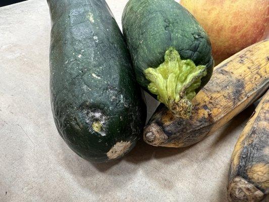 Molding zucchini, apples with holes and rotten bananas