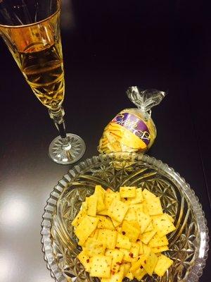 Relax with a glass of wine and spicy mini crackers.