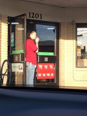 Yup!! She's been smoking while holding the door open as customers went in and out.