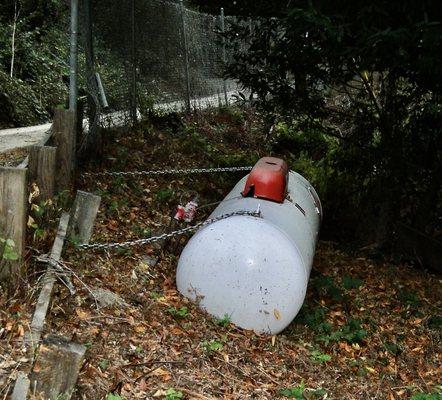 This was chained to a fence and post on top of a failing retaining wall. Illegal much??