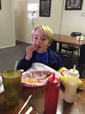 My brother finishing off some of the food. For some reason he asked for potato chips.