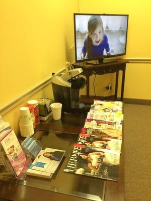 Keurig and plenty of magazines! (The office isn't a weird yellow color, just the picture.)