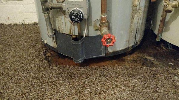 Deteriorated water heater in our laundry room.