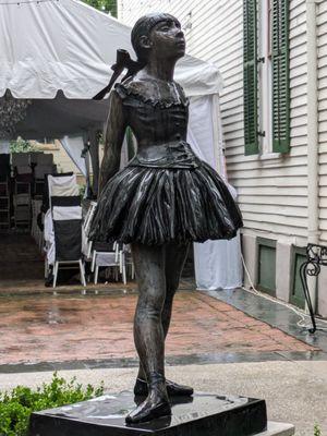 Statue with courtyard and wedding set up in background