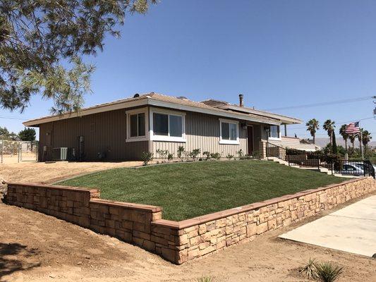 Retaining wall with veneer stone.