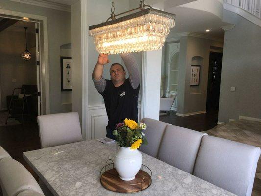 Hung beautiful glass chandelier over dinning room table.