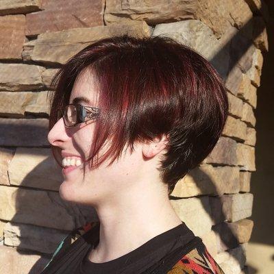 Short sassy haircut with fun burgundy hair color in it