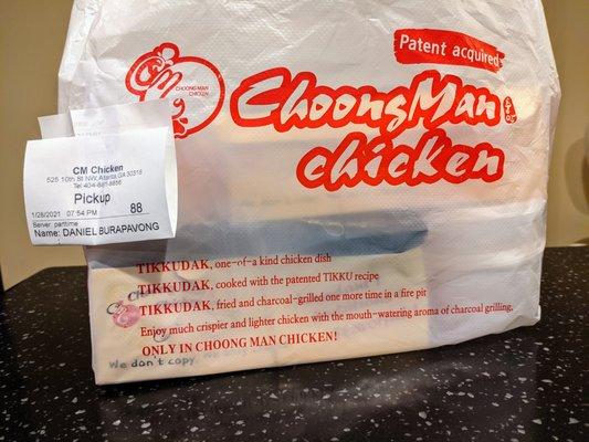 Takeout bag with Choong Man Chicken branding and marketing language.