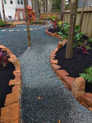 Flagstone as stepping stones on black star gravel