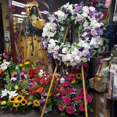 Offerings of flowers that  Devoted people bring to  Santa Muerte.