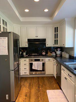 After: Kitchen (she also suggested we paint the inside of the cabinets with windows a dark blue so that it softened the dark countertop)