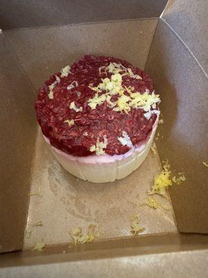 Limoncello cake with raspberry topping and grated lemon zest