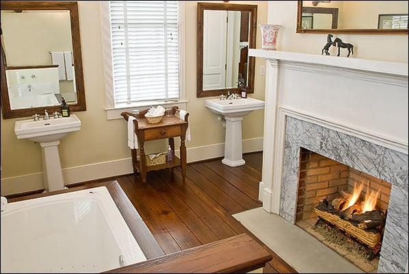 Spacious bathroom  with fireplace opposite the hydro therapy whirlpool tub.