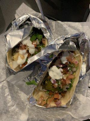 Lime shrimp (left) and El Pastor (Right), each on a flour tortilla, with cilantro/onions, jalapeños, sour cream, and Pico.