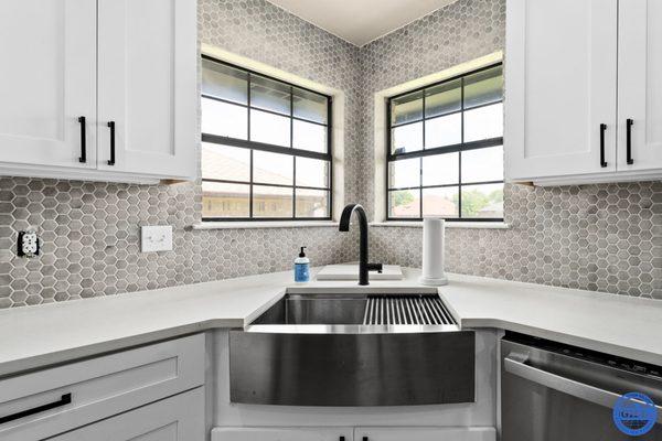 This apron front sink and marble hexagon mosaic give a "WOW" factor to new bright kitchen!