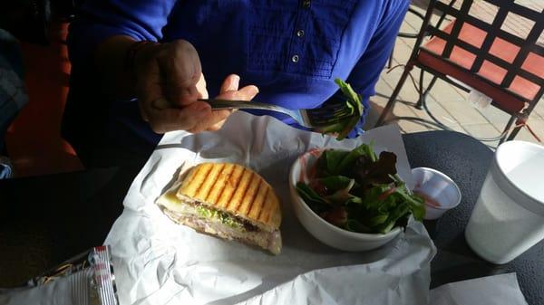 The other half of the turkey panini with a fresh salad.