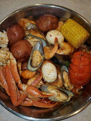 Seafood boil w/snow crablegs,  green mussels,  lobster tail, jumbo shrimp,  corn, potatoes and eggs