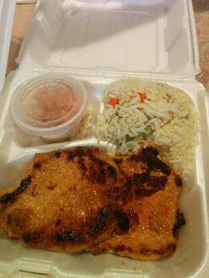 Pork marinated in spice served with rice and salad.