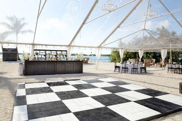 Clear Top Tent + Checkered Dance Floor + Black Chiavari Chairs + Decorated Tables + Beach Front Wedding