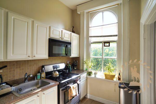 Modern kitchen with a window perfect for your potted herb garden.