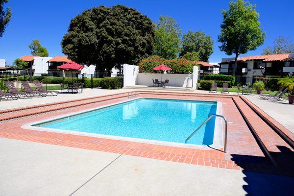 Pool area with lush landscape in background