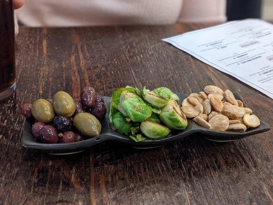 Appetizer of olives, Brussels sprouts, and almonds