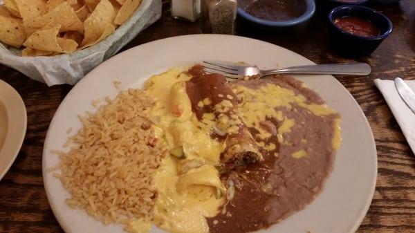 1 beef enchilada w/chili con carne, 1 cheese enchilada w/cheese sauce, rice & beans.