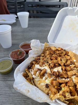 Chicken nachos loaded and a salsa bar