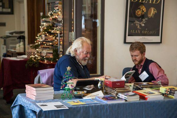 Writer and editor Richard Harteis chats with staffer Tyler West during the 2016 Small Press Book Fair