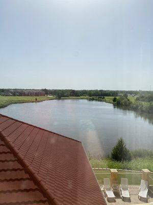 Pond/lake and lounge chairs on downstairs patio outside--as seen from our third floor room