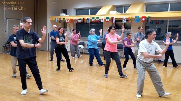 Holding a posture from the traditional form of Tai Chi.