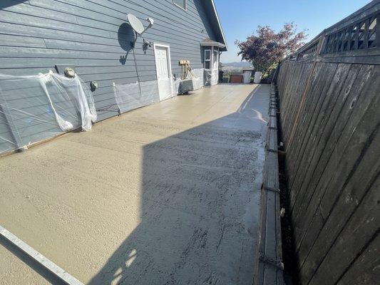 Wet concrete for an rv pad on the side of the house with a curb to help direct water to drains