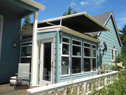 Retractable shade over sun room