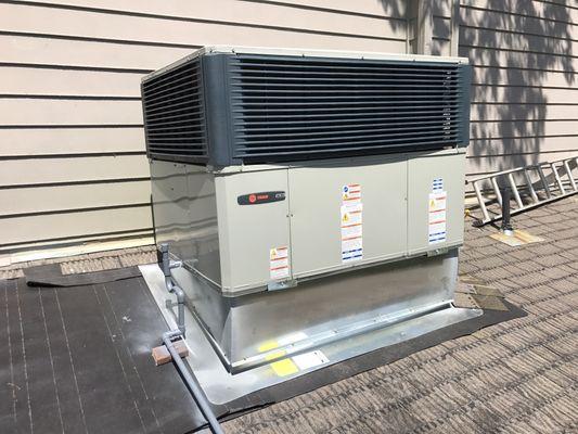 New 4 ton 15 seer, Trane unit. The roofer will re-shingle around the new curb.