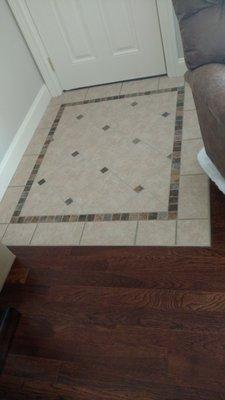 Custom ceramic tile with Hickory hardwood floor.