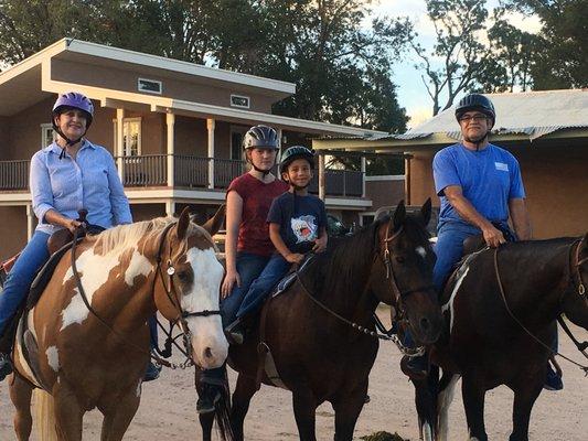 Grandma, Grandpa, and their youngest grandson back from a trail ride.