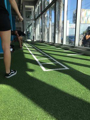 This turf/stretching area is the perfect spot to wind down after a workout.