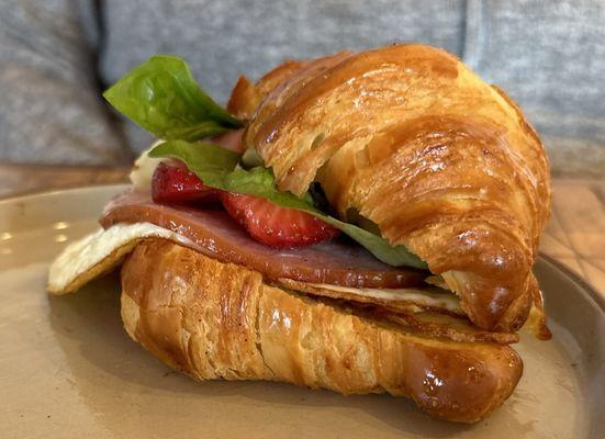 Ham and egg croissant sandwich with strawberries and honey. Wife loved it.