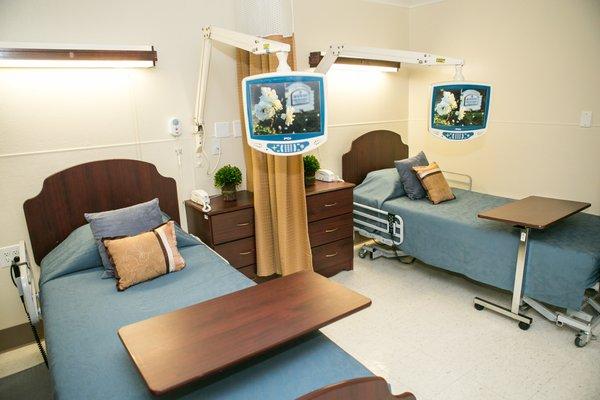 An example of one of Rosewood's semi private rooms with telescoping TV's for every patient.